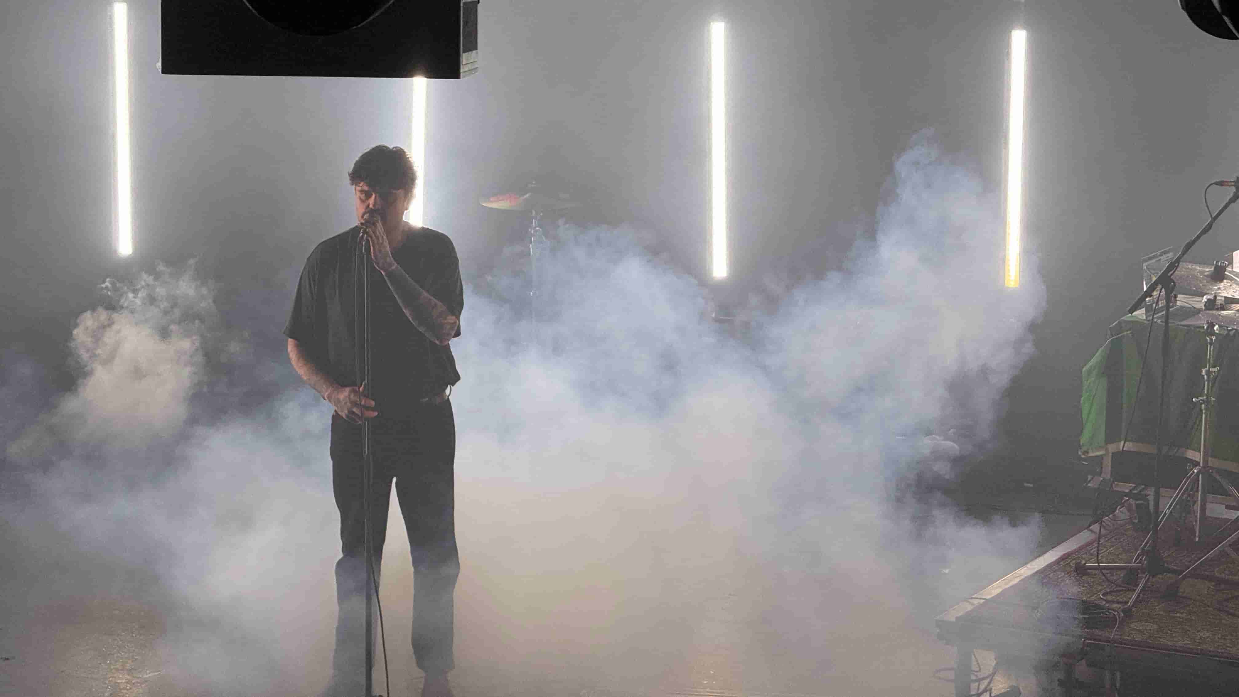Callum, lead singer of Big Special surround by white smoke
