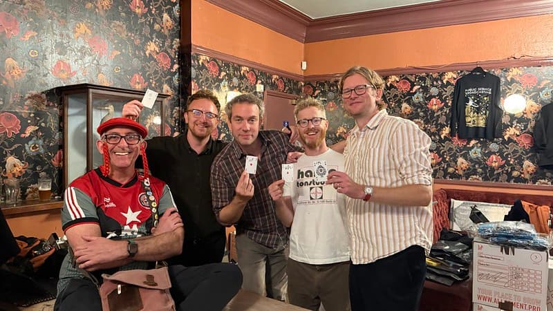 Me with Public Service Broadcasting at The Star of Kings, they are each holding an Ace playing card whish they have signed