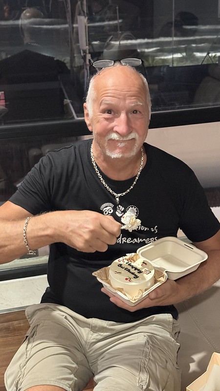 Tony delightedly eating a birthday cake