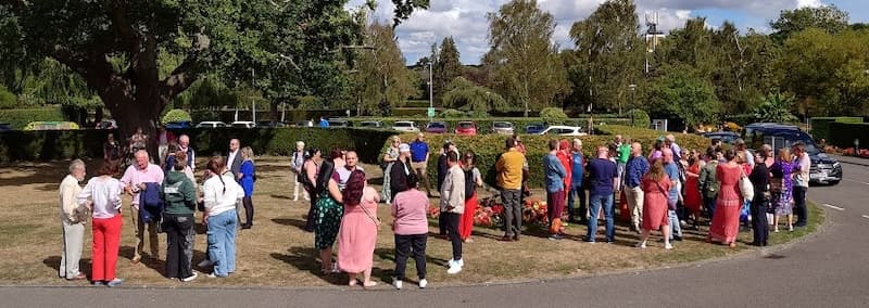 A rainbow of friends waiting to go into Sarah's funeral
