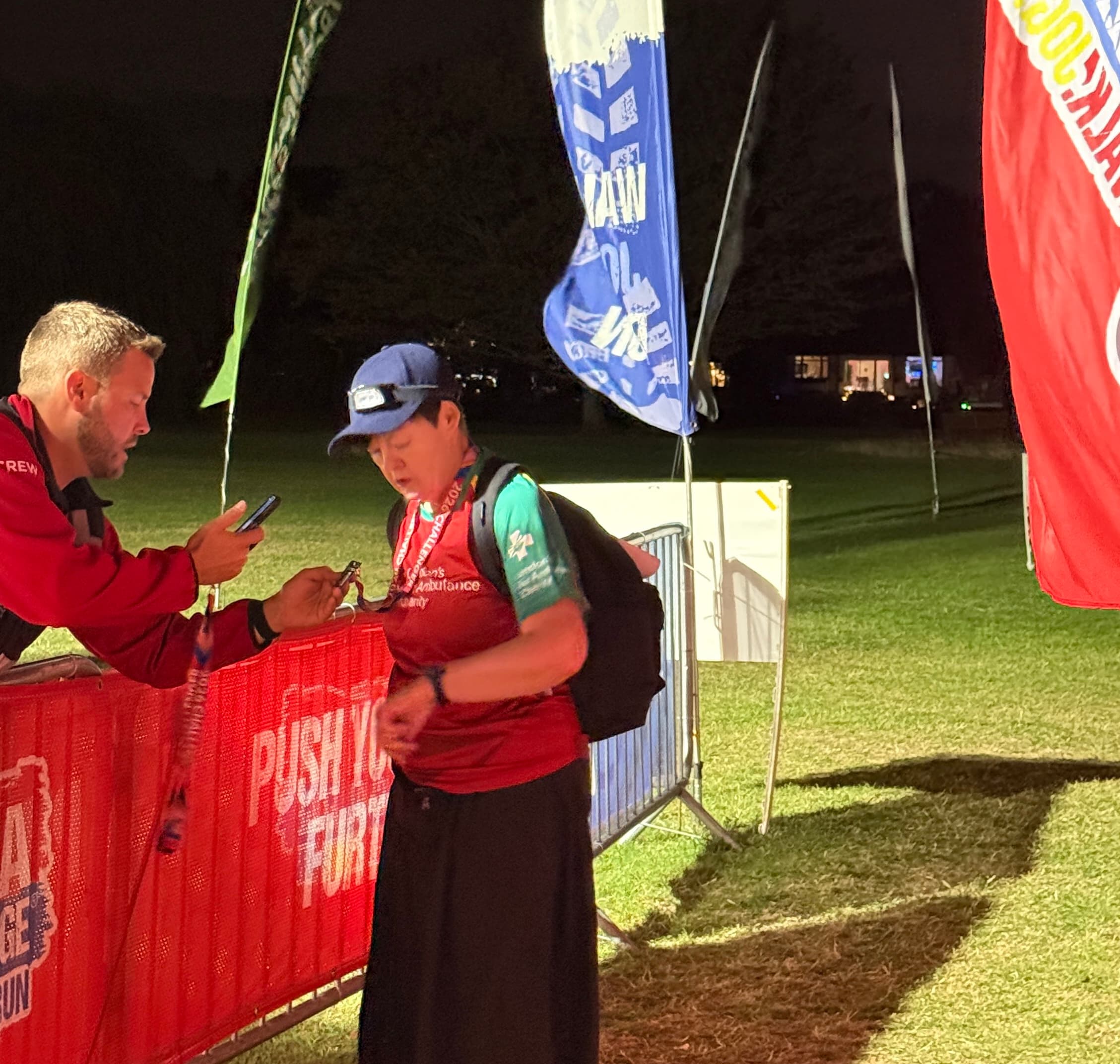 Susan getting her badge scanned at Rest Stage 3 of Thames Path Challenge, halfway only 50km left to walk